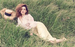 Anne Hathaway looks gorgeous posing in a countryside field